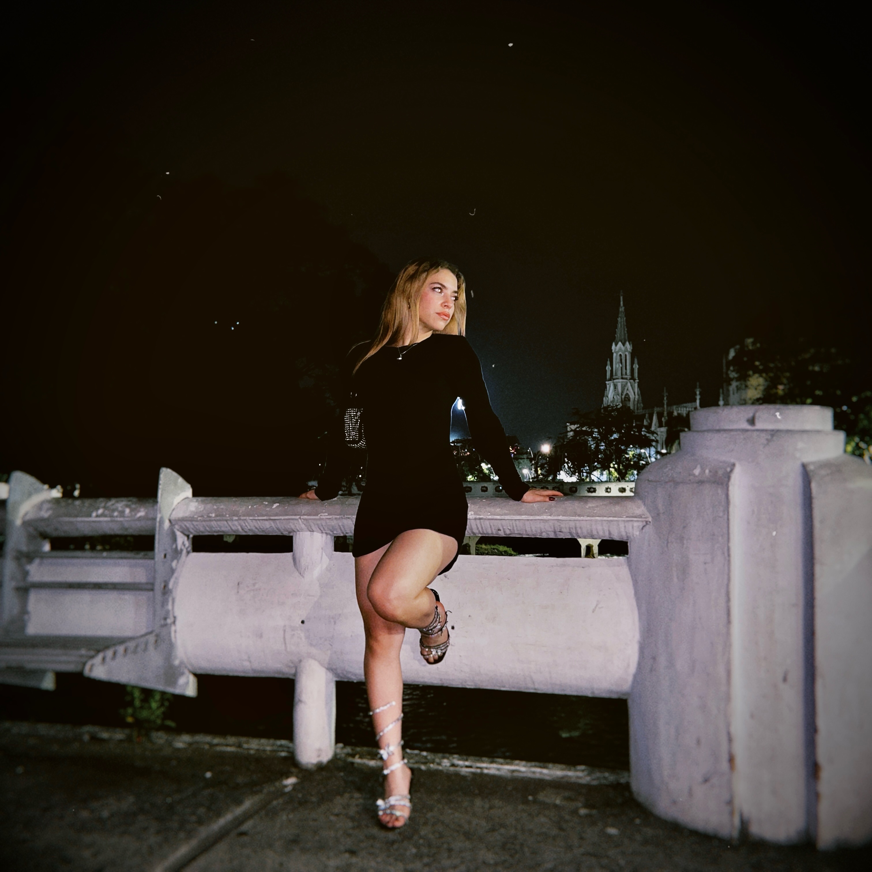 Bella outdoors at night wearing a black outfit