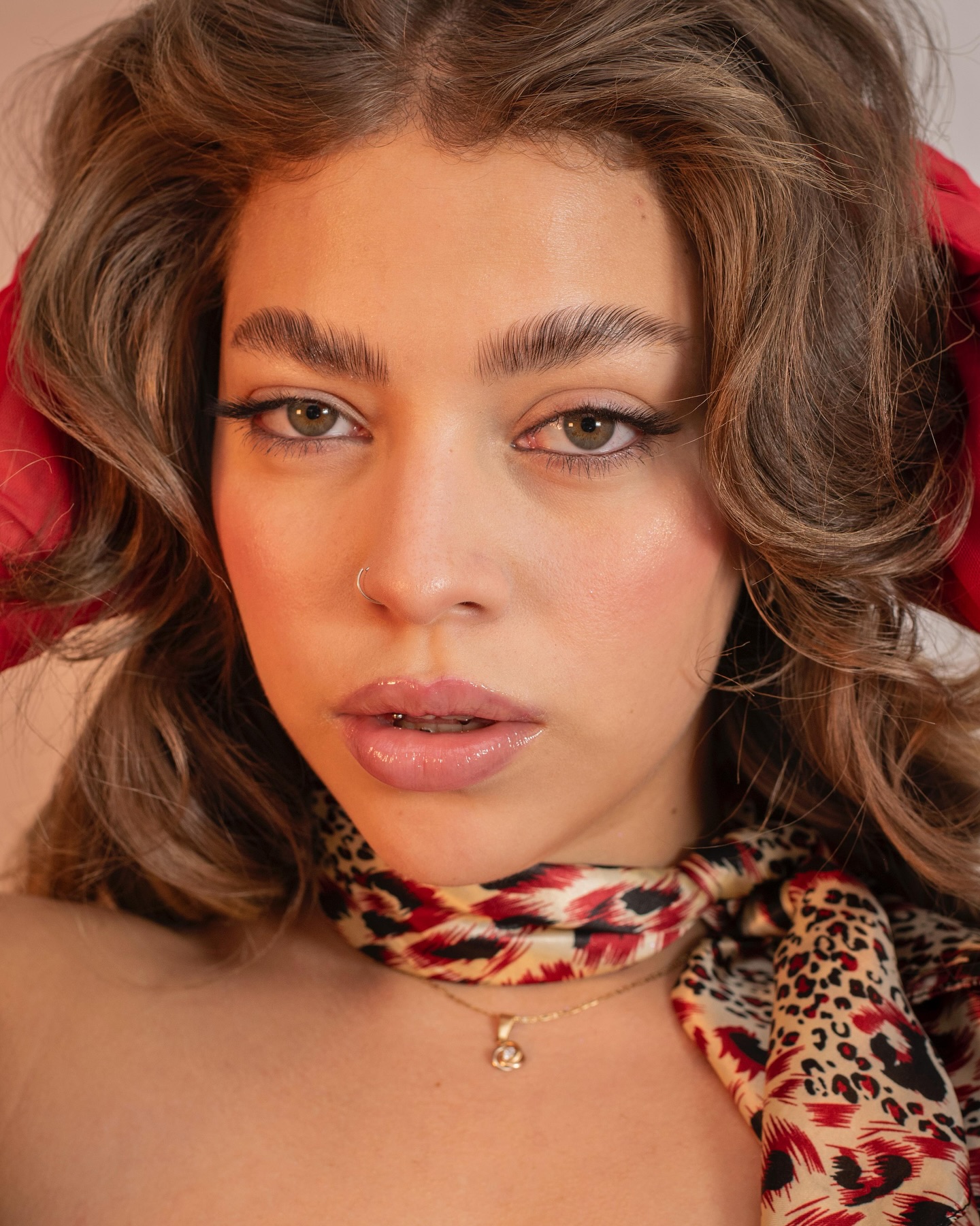 Bella Swang portrait with green eyes and a patterned scarf